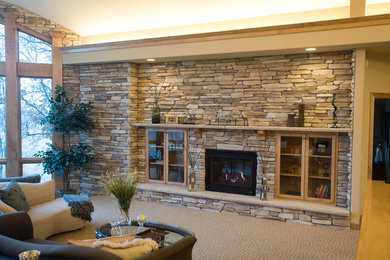 Inspiration for a large classic enclosed games room in Minneapolis with beige walls, carpet, a two-sided fireplace, a stone fireplace surround and no tv.