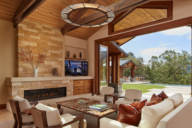 Mountain style living room photo in San Francisco with beige walls, a ribbon fireplace, a stone fireplace and a wall-mounted tv