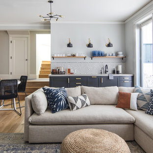 Family room - large transitional enclosed medium tone wood floor and brown floor family room idea in San Francisco with gray walls