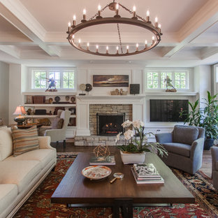 Inspiration for a large transitional open concept dark wood floor and brown floor family room remodel in Cincinnati with white walls, a standard fireplace, a stone fireplace and a wall-mounted tv
