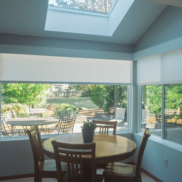 Motorized privacy roller shades, with wooden cap valance.