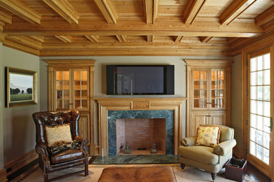 Inspiration for a timeless enclosed dark wood floor family room remodel in New York with green walls, a standard fireplace, a wood fireplace surround and a wall-mounted tv