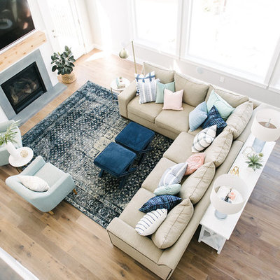 Inspiration for a large transitional medium tone wood floor family room remodel in Salt Lake City with gray walls, a standard fireplace and a wall-mounted tv