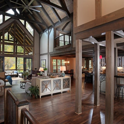 Family room - rustic open concept dark wood floor and brown floor family room idea in Atlanta with beige walls