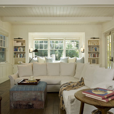 Inspiration for a timeless family room remodel in San Francisco with beige walls, a standard fireplace, a wall-mounted tv and a plaster fireplace