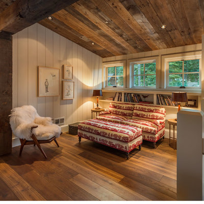 Mid-sized mountain style loft-style medium tone wood floor family room library photo in Sacramento with white walls, no fireplace and no tv