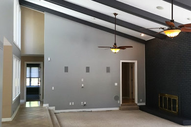 Example of a large transitional open concept carpeted family room design in St Louis with gray walls, a corner fireplace and a brick fireplace