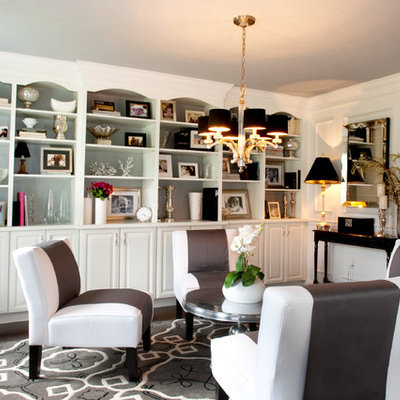 Example of a classic enclosed dark wood floor family room design in Boston with white walls and no tv