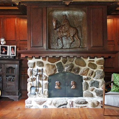 Inspiration for an eclectic enclosed medium tone wood floor family room remodel in Montreal with beige walls, a standard fireplace and a stone fireplace