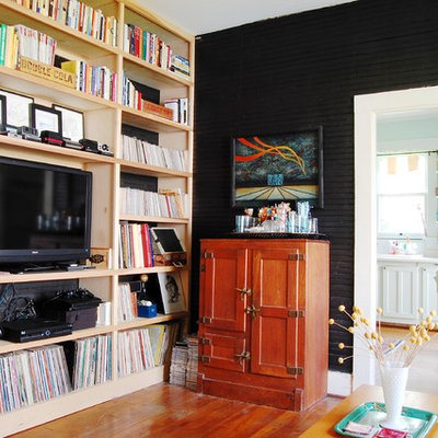 Example of an eclectic family room library design in New York
