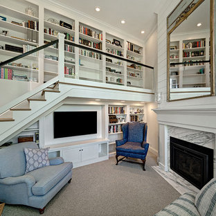 Example of a small beach style carpeted and gray floor family room library design in Minneapolis with a standard fireplace, a stone fireplace, a media wall and white walls