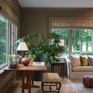 Example of a large enclosed light wood floor family room design in New York with green walls