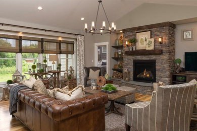 Inspiration for a mid-sized rustic open concept light wood floor family room remodel in Boston with gray walls, a standard fireplace, a stone fireplace and a tv stand