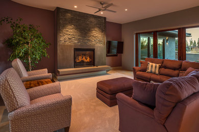 Large trendy enclosed carpeted family room photo in Other with gray walls, a standard fireplace, a wall-mounted tv and a concrete fireplace