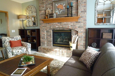 Family room - mid-sized transitional enclosed carpeted family room idea in Omaha with blue walls, a standard fireplace and a brick fireplace