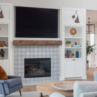 Family room - small coastal open concept light wood floor family room idea in Orange County with white walls, a standard fireplace, a tile fireplace and a wall-mounted tv