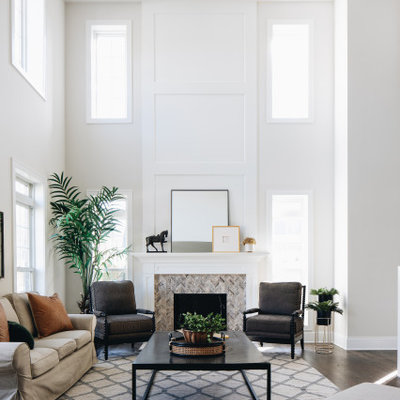 Example of a transitional open concept dark wood floor and brown floor family room design in Chicago with white walls
