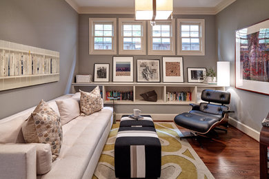 Inspiration for a mid-sized transitional enclosed medium tone wood floor and brown floor family room remodel in Dallas with gray walls