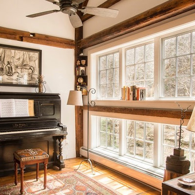 Inspiration for a mid-sized rustic open concept medium tone wood floor and brown floor family room remodel in Burlington with a music area, beige walls, no fireplace and no tv