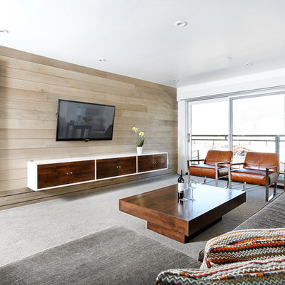 Example of a large trendy open concept carpeted and gray floor family room design in Denver with white walls, a wall-mounted tv and no fireplace
