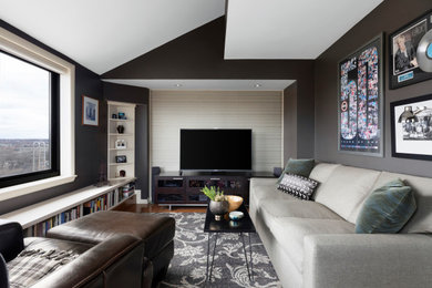 Family room - transitional enclosed dark wood floor, brown floor and vaulted ceiling family room idea in Minneapolis with black walls and a tv stand