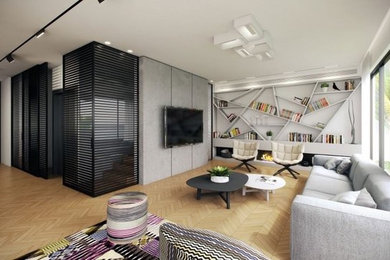 Foto de sala de estar abierta contemporánea grande con paredes blancas, suelo de madera clara y televisor colgado en la pared