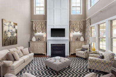 Example of a mid-sized open concept medium tone wood floor family room design in Other with beige walls, a standard fireplace, a wood fireplace surround and a wall-mounted tv
