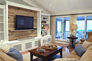 Example of a large farmhouse open concept family room design in Other with gray walls and a media wall