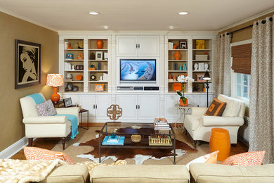 Foto de sala de estar con biblioteca abierta tradicional renovada de tamaño medio con paredes beige, suelo de madera en tonos medios y pared multimedia