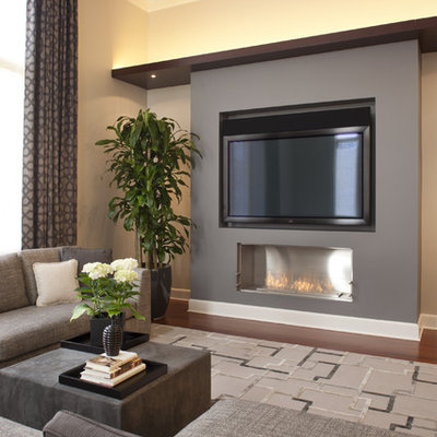 Trendy dark wood floor family room photo in Chicago with beige walls, a ribbon fireplace and a wall-mounted tv