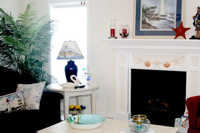 Example of a large beach style family room design in New York with a standard fireplace