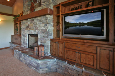 Example of a mid-sized mountain style enclosed dark wood floor family room design in Other with white walls, a standard fireplace, a stone fireplace and a media wall