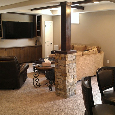 Mid-sized elegant open concept carpeted and beige floor family room photo in Denver with beige walls, a standard fireplace, a stone fireplace and a wall-mounted tv