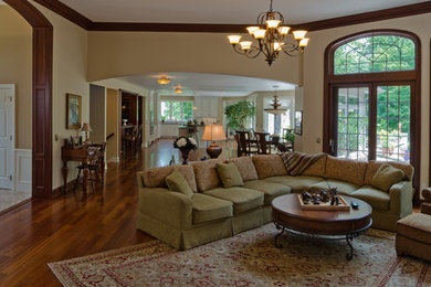 This is an example of a medium sized classic open plan games room in Other with white walls, medium hardwood flooring, a standard fireplace, a tiled fireplace surround and a freestanding tv.
