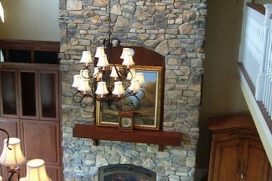 Inspiration for a modern family room remodel in Seattle with a standard fireplace and a stone fireplace