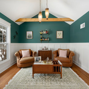 Inspiration for a small timeless open concept medium tone wood floor and brown floor family room remodel in Kansas City with green walls and a bar