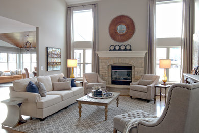 Mid-sized transitional open concept medium tone wood floor living room photo in Chicago with white walls, a standard fireplace, a stone fireplace and no tv