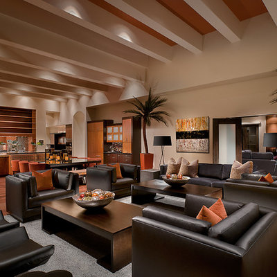 Family room - tropical open concept medium tone wood floor and brown floor family room idea in Phoenix with beige walls