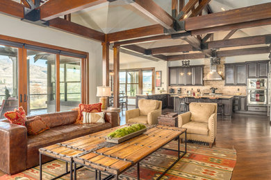Large mountain style open concept medium tone wood floor and brown floor family room photo in Seattle with white walls, a standard fireplace, a stone fireplace and a media wall