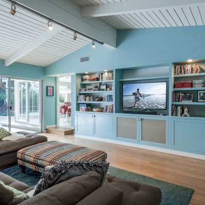 Inspiration for a transitional open concept medium tone wood floor, brown floor, shiplap ceiling and vaulted ceiling family room remodel in Los Angeles with blue walls, no fireplace and a tv stand