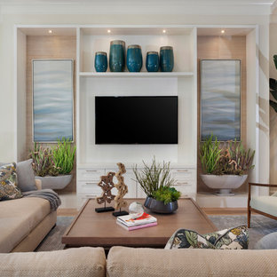 Example of a beach style open concept medium tone wood floor and brown floor family room design in Miami with beige walls and a wall-mounted tv