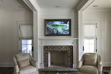 Family room - mid-sized enclosed family room idea in Charleston with a music area and a media wall
