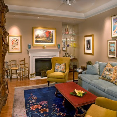 Family room - contemporary medium tone wood floor family room idea in DC Metro with beige walls and a standard fireplace