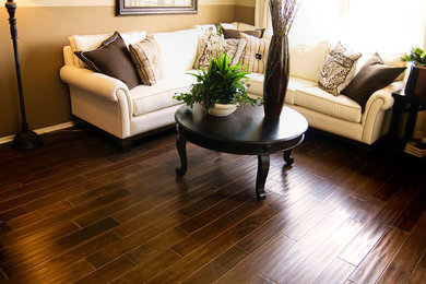 Example of a dark wood floor and brown floor family room design in Atlanta