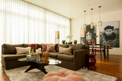 Mid-sized trendy open concept medium tone wood floor family room photo in Portland with white walls, a standard fireplace, a tile fireplace and a wall-mounted tv