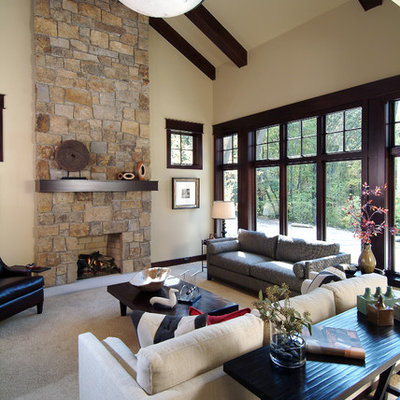 Inspiration for a timeless open concept family room remodel in Grand Rapids with beige walls, a standard fireplace and a stone fireplace