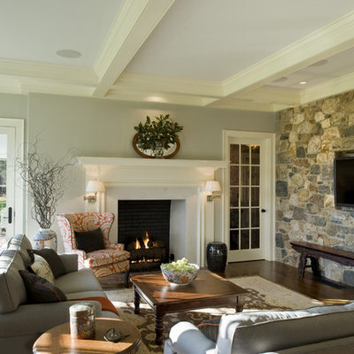 Elegant dark wood floor family room photo in Philadelphia with gray walls, a standard fireplace and a wall-mounted tv