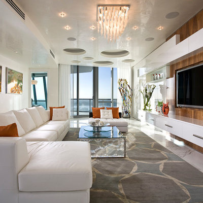 Family room - large contemporary open concept carpeted and white floor family room idea in Miami with beige walls and a media wall