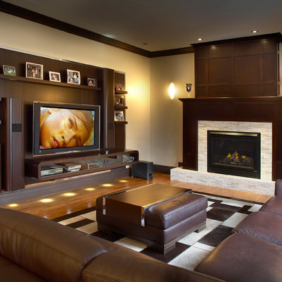 Inspiration for a contemporary medium tone wood floor family room remodel in Los Angeles with beige walls, a standard fireplace and a media wall