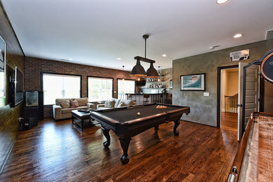 Example of a large urban enclosed dark wood floor and brown floor game room design in Other with multicolored walls, no fireplace and a wall-mounted tv